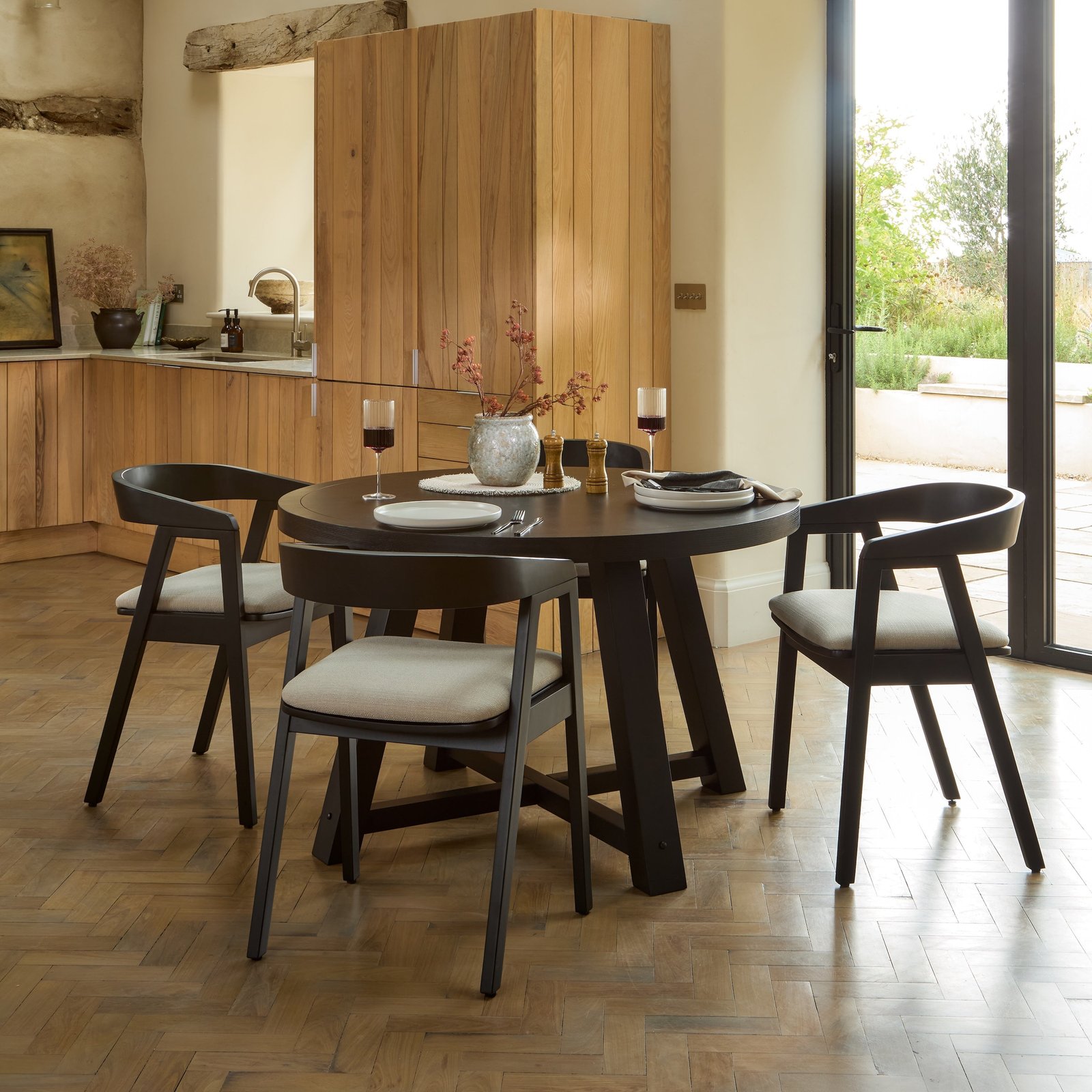 Charlotte Black Oak Round Dining Table Set - 4 Seater - Ella Black Oak Carver Chairs - Fawn Linen - Image 1