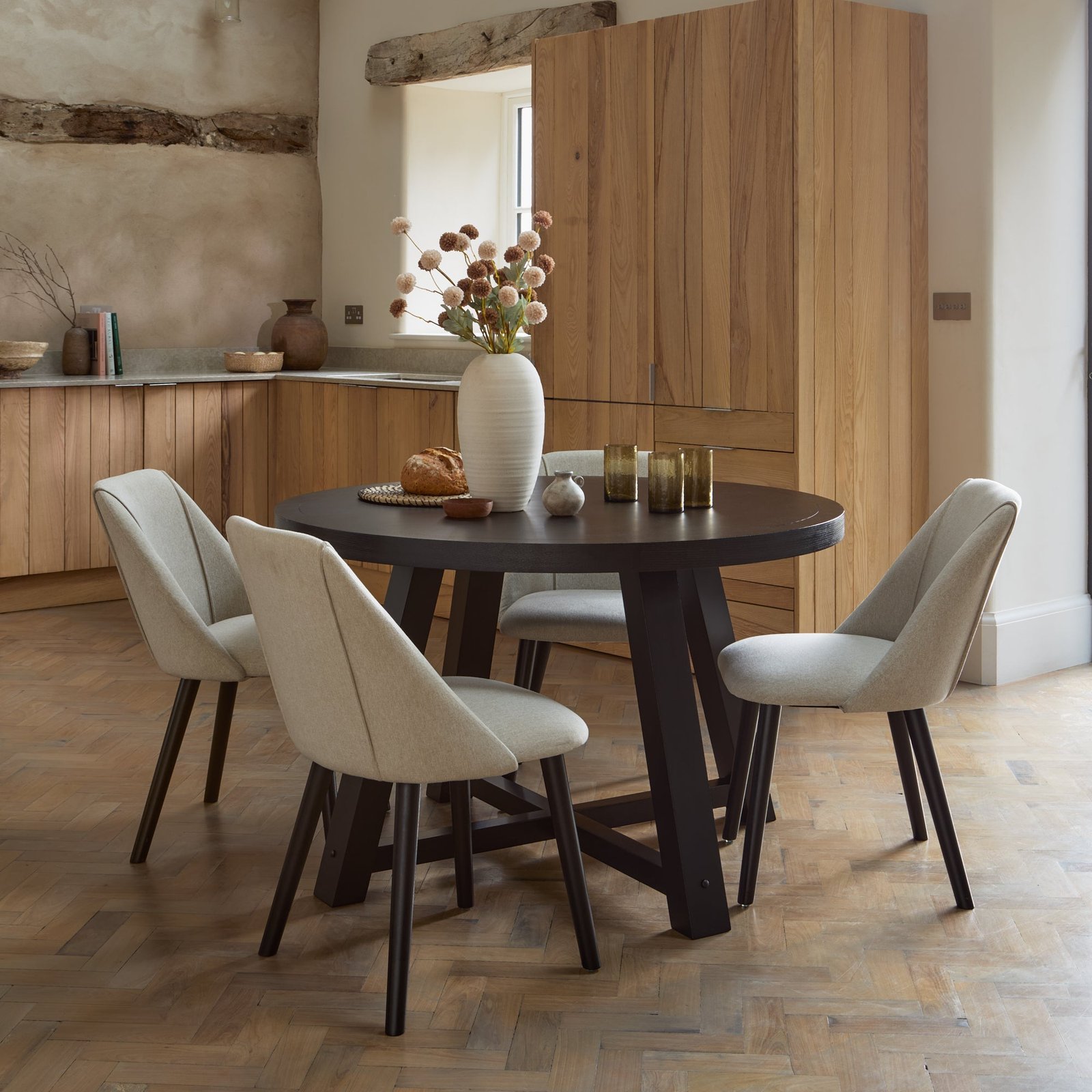 Charlotte Black Oak Round Dining Table Set - 4 Seater - Freya Sand Dining Chairs - Black Oak Legs - Image 1