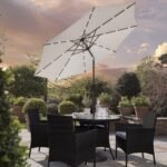 Kemble 4 Seater Rattan Round Dining Set with Cream LED Premium Parasol & Parasol Rain Cover - Black Weave