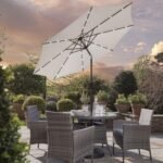Kemble 4 Seater Rattan Round Dining Set with Cream LED Premium Parasol & Parasol Rain Cover - Grey Weave