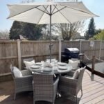 Kemble 6 Seater Rattan Round Dining Set with Cream LED Premium Parasol & Parasol Rain Cover - Grey Weave - Image 2