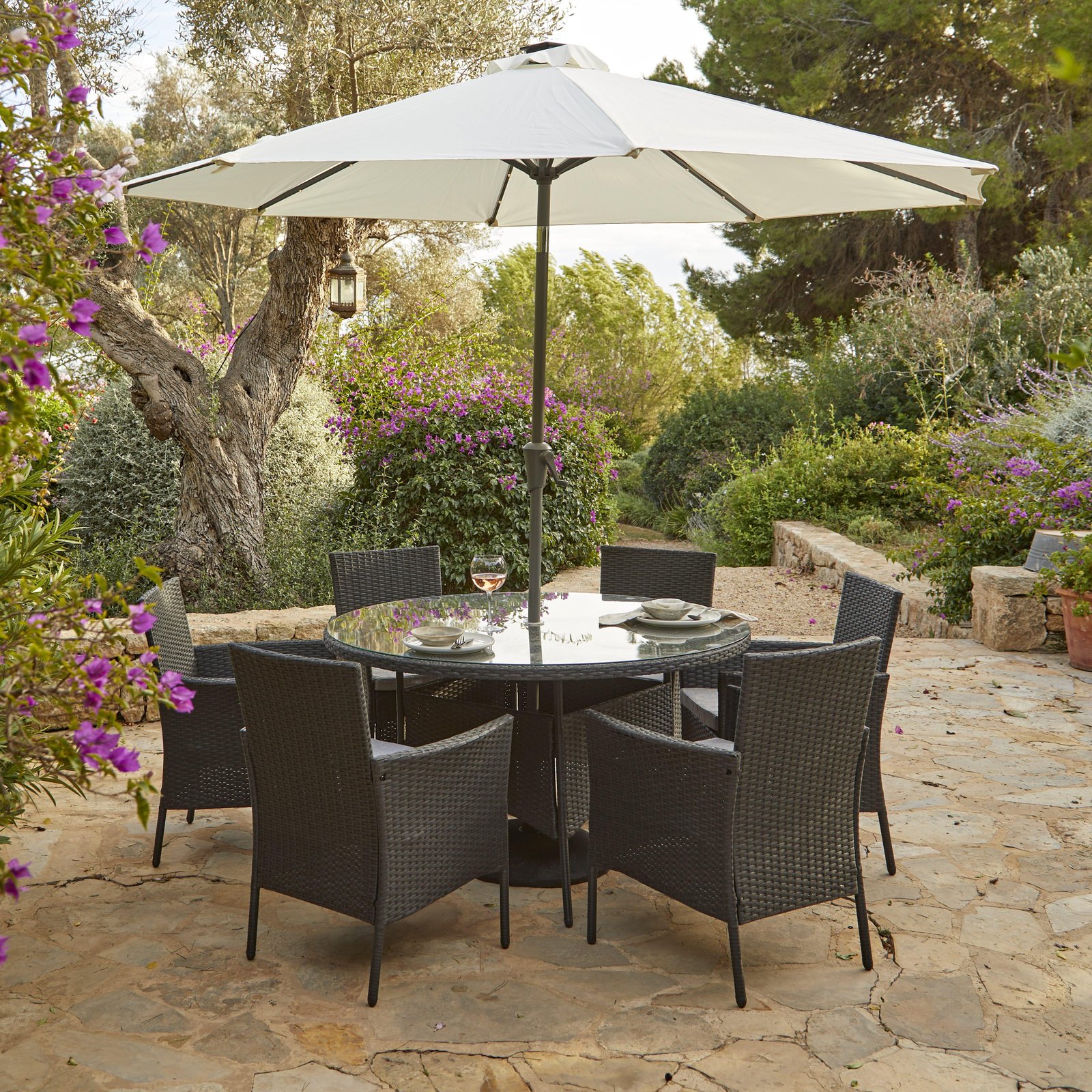 kemble-6-seater-rattan-round-outdoor-dining-set-with-led-premium-parasol-black-laura-james-1 Kemble 6 Seater Rattan Round Garden Dining Set with Cream LED Premium Parasol - Black Weave