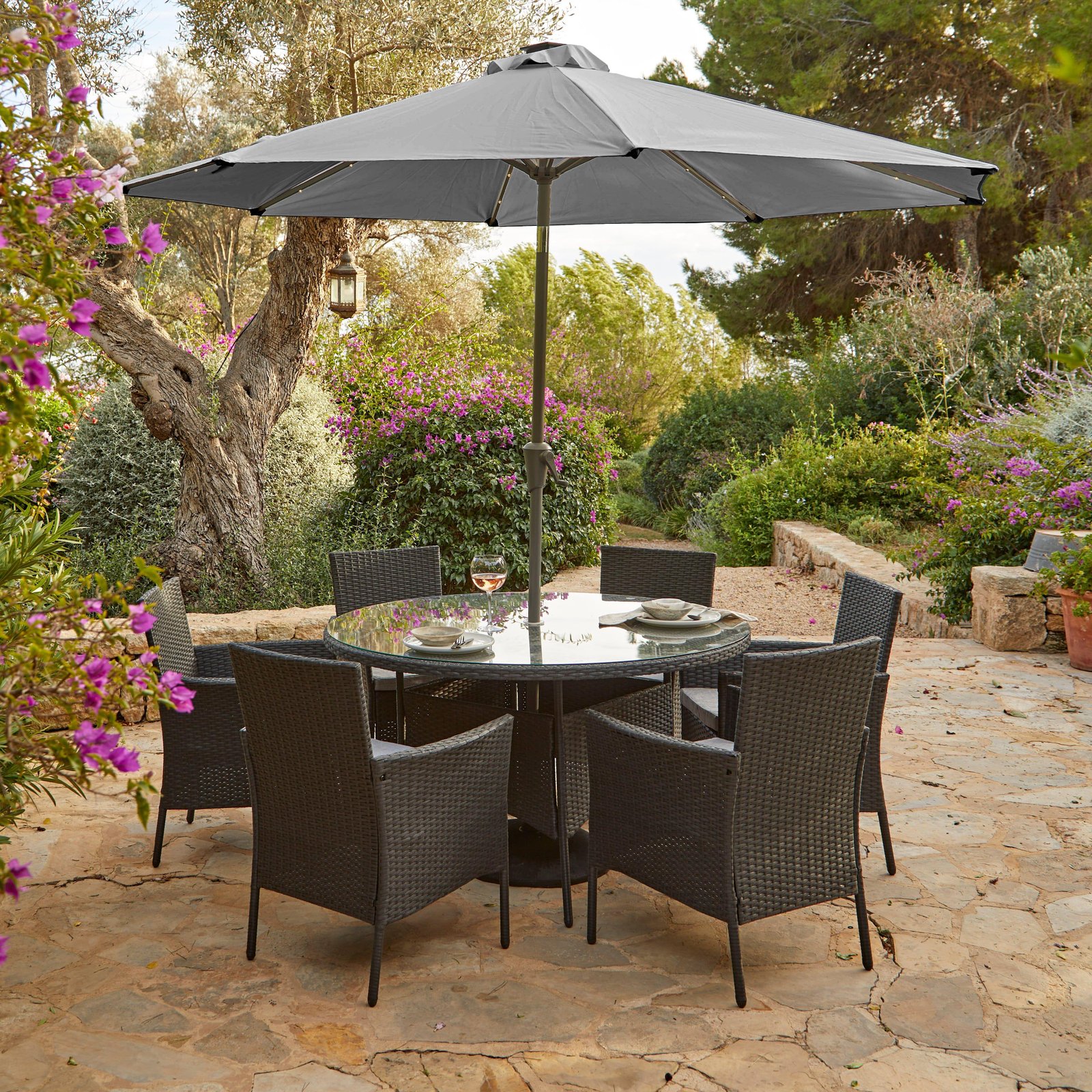 kemble-6-seater-rattan-round-outdoor-dining-set-with-premium-parasol-and-parasol-rain-cover-black-laura-james-1 Kemble 6 Seater Rattan Round Garden Dining Set with Grey LED Premium Parasol & Parasol Rain Cover - Black Weave